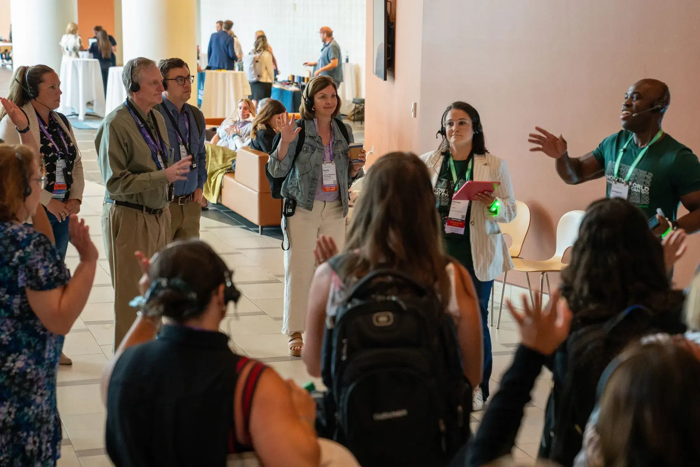 Tour guide speaking through a headset to a group of attendees wearing wireless headsets during an interactive event tour.