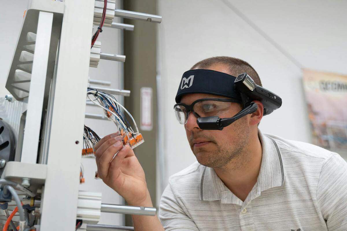 Man Using Assisted Reality Headset To Identify Wires